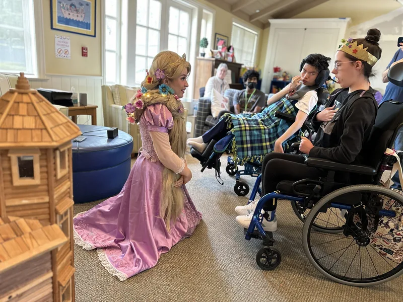 Jordyn Foley, dressed as Rapunzel, with young patients at George Mark Children’s House